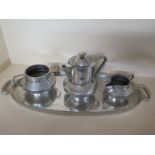 An Arts and Crafts Pewter Coffee Service - consisting Coffee Pot, Milk,