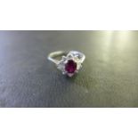 An 18ct White Gold Ruby and Diamond Cluster Ring - the central ruby approximately 6 mm x 5 mm x 3