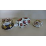 Three Royal Crown Derby Paperweights - two in the form of Pigs, one as a Frog - in good condition,