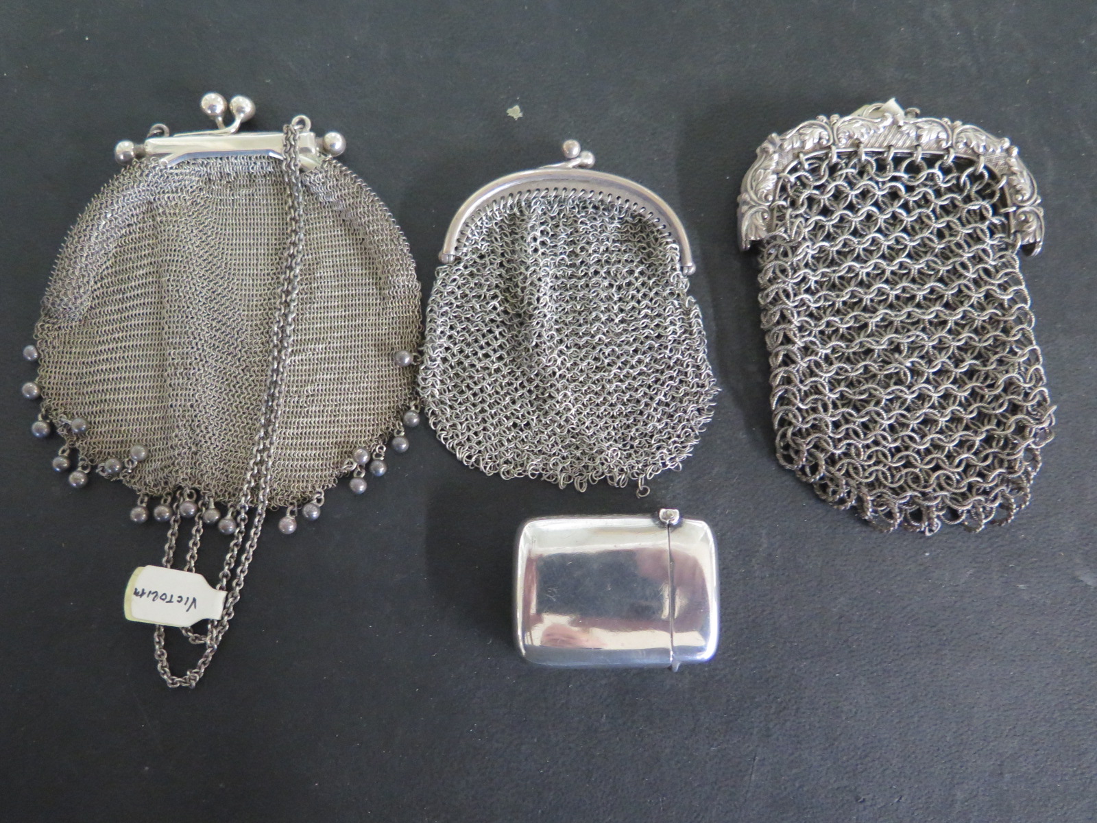 Three chain mail purses - one hallmarked Birmingham 1859 and a silver vesta hallmarked Birmingham