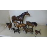 A large Beswick brown horse - 29 cm tall and six other horses,