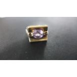 A 9ct Yellow Gold Single Stone Ring - possibly a pink sapphire - ring size O, approximately 6 grams,