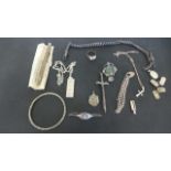 A selection of silver jewellery, items include ring, brooches, bangle, watch chain,