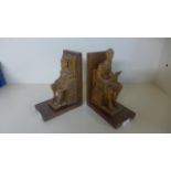 A pair of carved wooden book-ends featuring figures seated on thrones