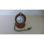 A Silver Pocket Watch with base metal chain and later wooden stand - watch working in saleroom -