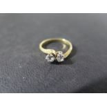 An 18ct yellow gold two stone diamond crossover ring - each diamond approx 0.