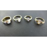 Four 9ct Yellow Gold Opal Rings - ranging in size from G to Q - approximate total weight 10.