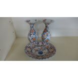 A pair of Imari pattern vases with flared rims and ovoid bodies and an Imari pattern swallow bowl,