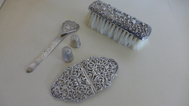 A silver nurses buckle, a silver back brush,