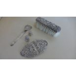 A silver nurses buckle, a silver back brush,