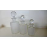 A set of Three Graduating Scent Cologne Bottles - with gilt decoration - 22 cm to 15 cm tall -
