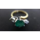 An 18ct Yellow Gold Ring - the central round cut emerald approx 1.
