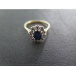 An 18 ct yellow gold sapphire and diamond cluster ring - size M - approximately 2.
