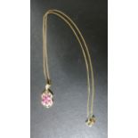 A 9ct gold spinel and diamond pendant on a 46 cm long chain - pendant 2.5 cm long - approx 4.