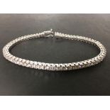 A Princess cut diamond tennis bracelet 18ct white gold comprising 65 princess cut diamonds,