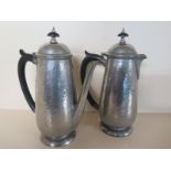 A Tudric Pewter Tea-Pot and Coffee pot - both with hammered finish - both in good order - finial to