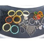 A quantity of costume jewellery including Bakelite bangles, napkin rings,
