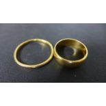 Two 22ct Yellow Gold Band Rings - sizes V and K - total weight approximately 6 grams - some usage