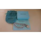 A silver Tiffany chain link bracelet with heart shaped return token - in good clean condition -