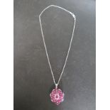 A silver pendant set with Madagascan ruby and white topaz - in good condition with certificate -