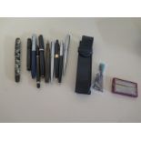 A selection of pens and other writing related items to include Parker Duofold and De La Rue - some