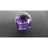 An 18ct White Gold Ring with a fine imperial amethyst to shoulder, approx 20.
