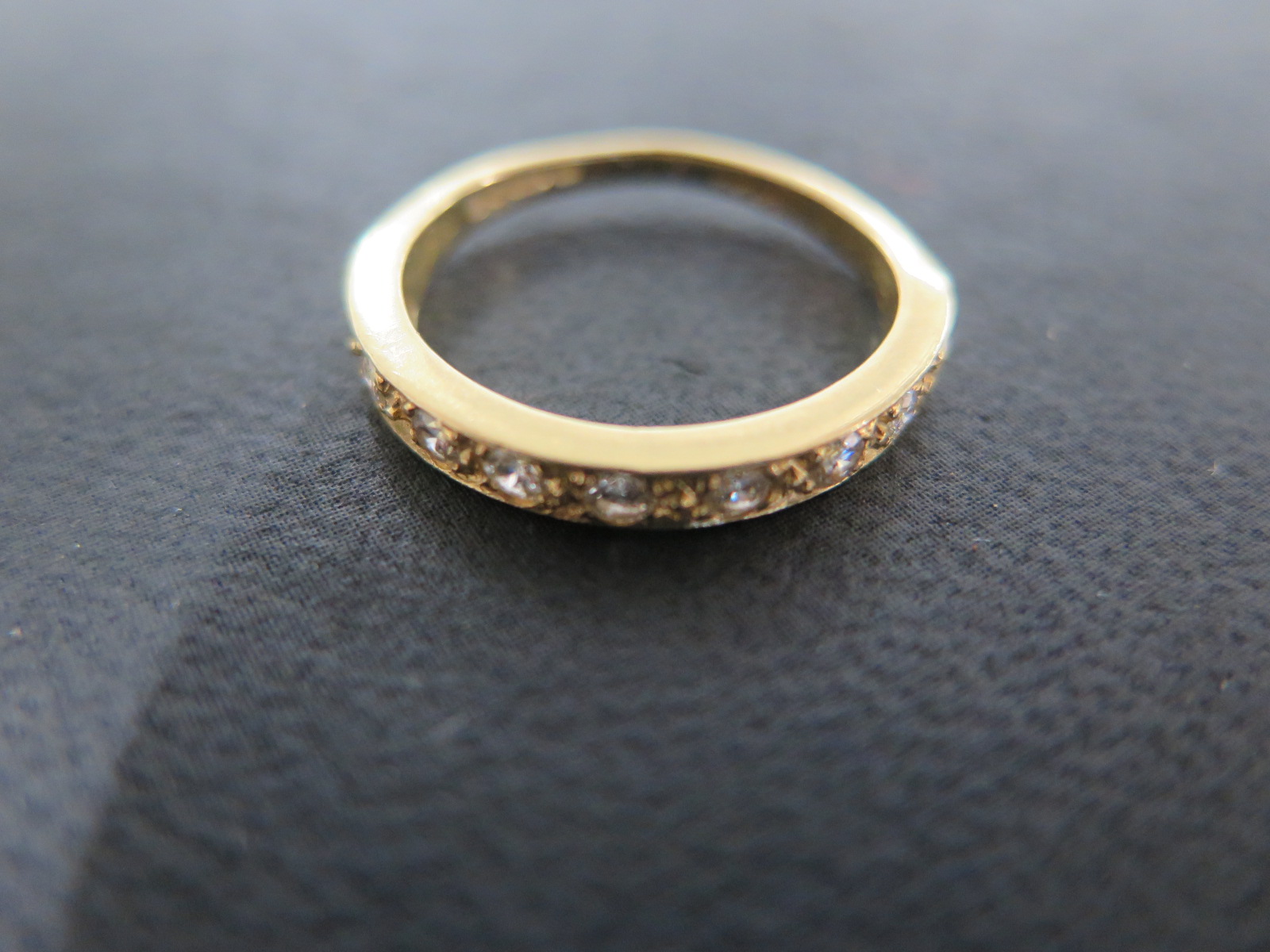 An 18ct Gold Modern Diamond Half Eternity Ring, 9 stones, round brilliant, Colour G/H,