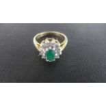 A Silver Gilt Dress Ring - Size N - the central green stone surrounded by twelve smaller clear