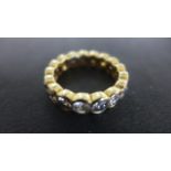 An 18ct Yellow Gold Eternity Ring set with seventeen diamonds each approx 0.