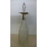 A cut glass decanter with silver collar,