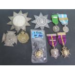 A selection of silver hallmarked belt buckles, cap badges,