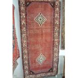 A hand knotted woolen Araak rug - 2.48m x 1.14m