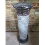 A classical Italian marble column or pedestal stand with grey base and capital and light grey