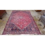 A hand knotted woollen rug, 260cm x 170cm - in good condition