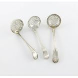 A small collection of three antique silver sifting spoons, comprising: one Fiddle, Thread and
