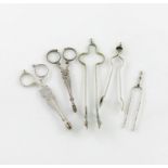 A collection of five pairs of silver sugar nips / tongs, comprising: a pair of 'Andiron' form,