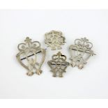 A collection of four late Victorian Scottish silver Luckenbooth brooches, unmarked, in the form of