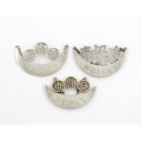 A collection of three Chinese silver wine labels, by Wang Hing, comprising: a pair of crescent form,