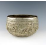 A Burmese metal ware bowl, circular form, embossed with figural scenes within foliate scroll