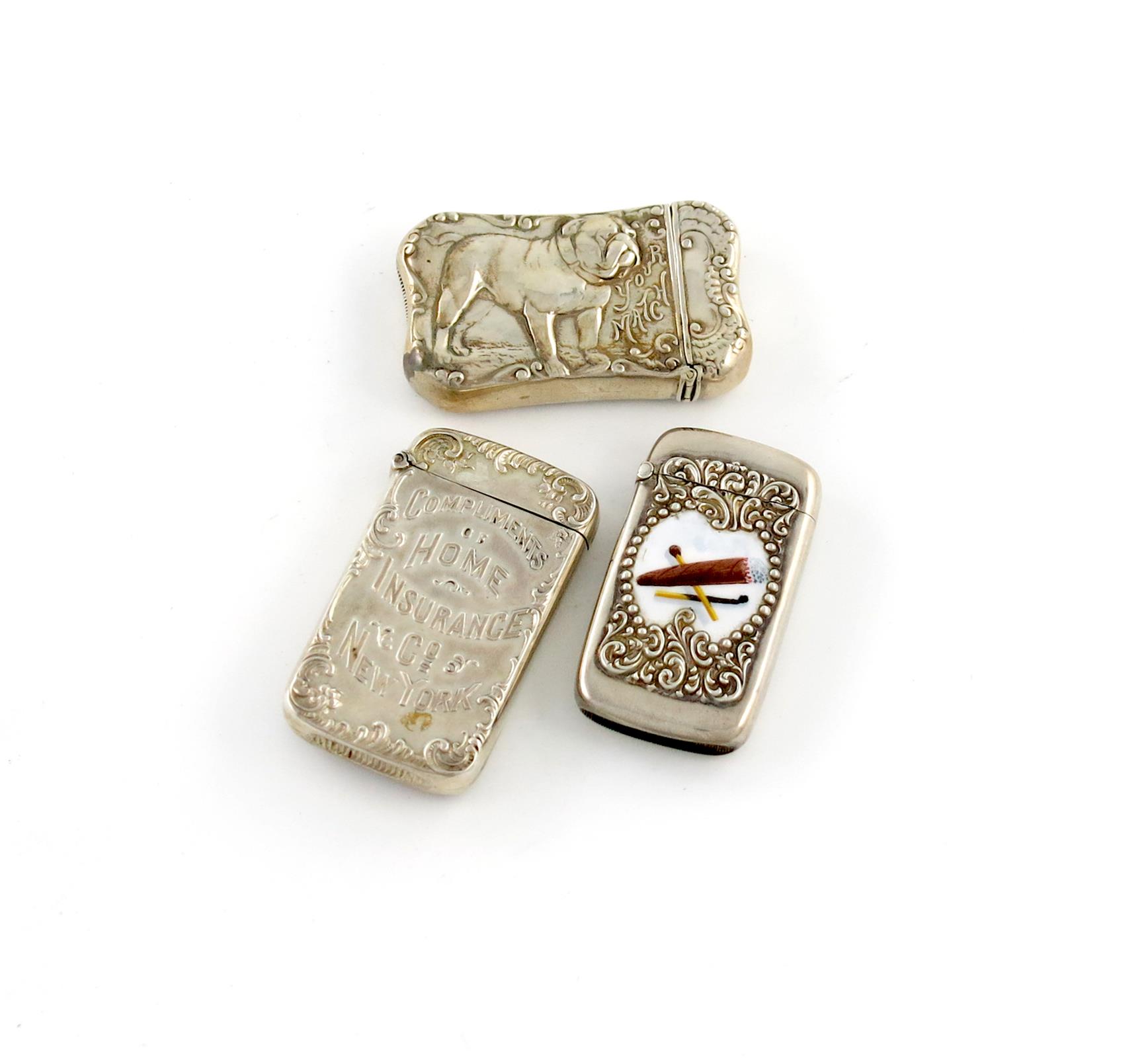 A collection of three American silver vesta cases, comprising: one with a scene of a bulldog and '