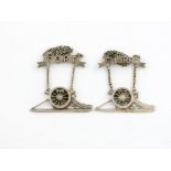 A pair of novelty Victorian electroplated wine labels, unmarked, modelled as field canons, with