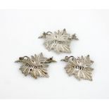 A small collection of three antique silver wine labels, various dates and makers, vine leaf form,