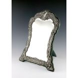 A late-Victorian silver dressing-table mirror, by H. Matthews, Chester 1900, shaped upright