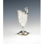 A George III silver cream jug, by Smith and Hayter, London 1793, helmet form, engraved decoration,