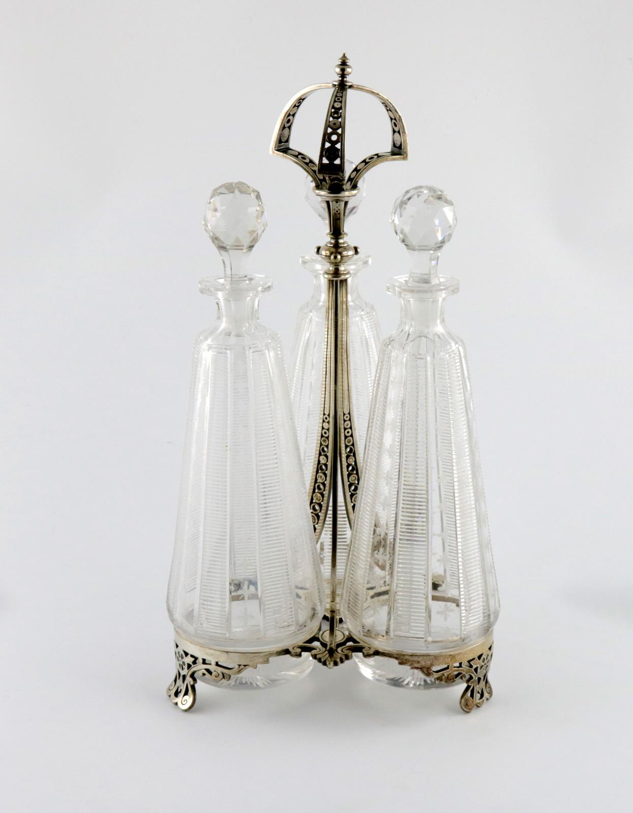 A Victorian electroplated three-bottle decanter stand, by Elkington, 1868, the frame of tapering