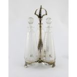 A Victorian electroplated three-bottle decanter stand, by Elkington, 1868, the frame of tapering