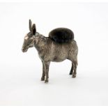 A novelty silver donkey pin cushion, maker's mark worn, Birmingham 1922, modelled in a standing