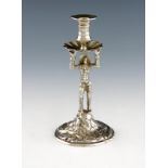 An unmarked silver harlequin taper stick, probably 18th century, modelled in a standing position,