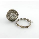 A continental silver filigree wool holder, unmarked, globe form, foliate scroll filigree decoration,