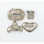 A small mixed lot of silver wine labels, comprising: one of shaped triangular form, maker's mark E.A